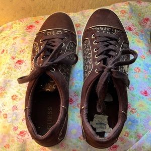 Guess brown sneakers with gold G logo on shoe plus gold symbol on sides.